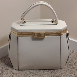 Cream colored large purse with gold accents